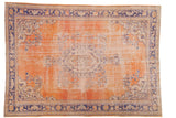 Distressed vintage Oushak carpet with faded brick red field, navy medallion, and ivory vinery.