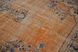 Distressed vintage Oushak rug texture with faded brick red abrashes and navy vinery.