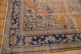 Distressed Oushak corner, faded brick red field, navy blue border, Rococo-inspired vinery.