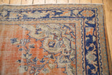 Distressed vintage Oushak rug corner with Rococo vinery in faded brick red and navy.