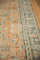 Oushak rug detail showing distressed apricot field and dusty teal border with palmettes and vinery.