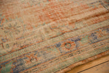 Worn texture detail of vintage distressed Oushak rug with apricot, ivory, and pale blue.