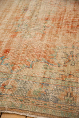 Distressed vintage Oushak carpet pile showing visible knot heads and faded apricot, mint, blue tones.