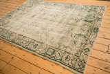 Vintage distressed Oushak corner with faded pale sea foam pile and Arts and Crafts inspired green motifs.