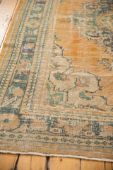 Distressed vintage Oushak rug border, showing apricot, ivory, mint green, and teal colors.