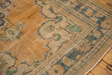 Vintage distressed Oushak rug corner, apricot peach, teal hues, and visible foundation.