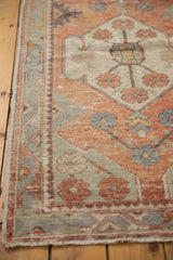 Secured ivory fringe, distressed pale blush brick red border of a vintage Oushak runner.
