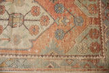 Distressed brick red, ivory, and sea foam green oversized floral motifs and border.