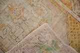 Distressed Oushak rug pile showing mostly even wear, foundation, and hand-knotted reverse.