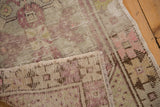 Distressed Oushak rug's worn pile texture and exposed foundation weave.
