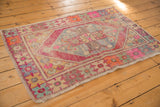 Distressed corner of the vintage Oushak rug, with worn pile and colorful geometric patterns.