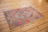 Angled view of a distressed Oushak rug, highlighting its vibrant geometric pattern and softened colorful palette.