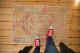 Distressed hand-knotted Oushak rug detail, with terra cotta rust, beige, and bubble gum pink.