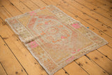 Textured pile and secured edge of distressed Oushak rug with bubble gum pink accents.