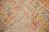 Distressed vintage Oushak rug corner showing worn pile, exposed foundation, and hand-knotted reverse.