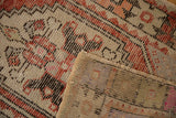 Distressed vintage Oushak rug showing worn pile, visible knot heads, foundation, and secured edge.