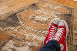 Distressed Oushak rug runner with faded rust terra cotta, charcoal, and antique ivory geometric motifs.