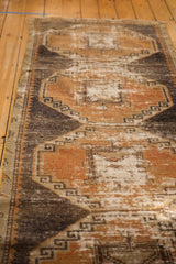 Distressed Oushak runner with worn texture and rust terra cotta, charcoal, ivory patterns.