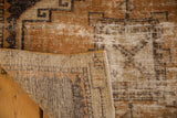 Distressed vintage Oushak runner with hard wear, revealing hand-knotted foundation and geometric pattern.