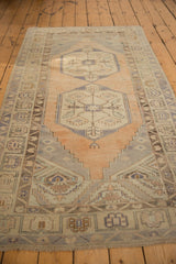 Distressed Turkish Oushak runner corner, showing faded apricot, silver geometric borders, and even wear.