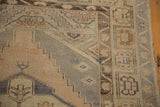 Distressed Oushak rug runner's geometric border in pale apricot, silver, and sea foam.