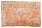 Orange distressed Oushak carpet, roundel medallion with pale blue and ivory patterns.