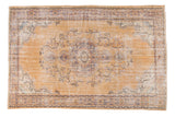 Distressed vintage Oushak rug with faded gold field, muted blue medallion, floral vines, 6'7