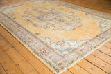 Vintage Distressed Oushak carpet, golden field with subtle etching and muted floral vines.