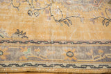 Distressed Oushak rug pile, featuring faded pale gold and blue floral border.