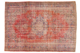 Vintage distressed Oushak carpet, central floral medallion, cherry red, dusty navy, and ivory tones.