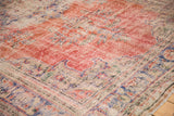 Hand knotted distressed Oushak rug with etched cherry red field and floral motifs.