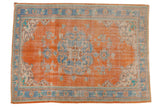 Tangerine orange distressed Oushak carpet, sky blue roundel medallion, floral vinery, 7' x 9'6