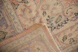 Distressed Oushak pile texture, with secured edge and woven foundation of the rug.
