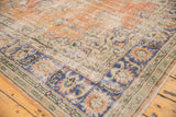 Vintage distressed Oushak rug border showing floral motifs and etching to foundation.