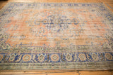 Distressed vintage Oushak carpet with apricot field, navy border, and etched foundation.