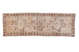 Vintage distressed Oushak runner with muted mauve, ivory, and brown triple diamond medallions. 2'10