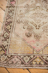 Vintage distressed Oushak runner corner with etched foundation, pale mauve, ivory, brown.
