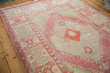 Evenly worn texture on the knot heads of the wide raspberry red border of a vintage Oushak rug.