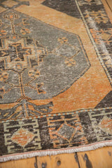 Distressed Oushak runner with pale rust, charcoal geometric patterns and exposed foundation.