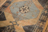 Geometric gray-blue medallion detail on a distressed pale rust Oushak runner.