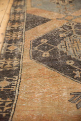 Distressed Oushak runner close-up: charcoal brown geometric medallion, pale rust field, and worn pile.