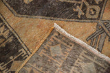 Distressed Oushak rug runner corner, showing worn pale rust pile, cream fringe, and hand-knotted reverse.