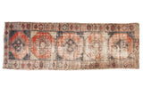 Vintage Distressed Oushak runner with faded brick red, charcoal, and ivory medallion guls. 3'8