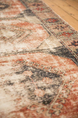 Vintage distressed Oushak runner with worn brick red, ivory, and charcoal texture.