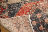 Distressed pile, hand-knotted foundation, and fringe of a Vintage Oushak runner.