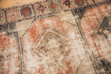 Distressed texture of vintage Oushak runner; brick red, ivory, and charcoal paneled gul.