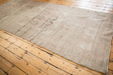 Distressed Oushak runner with muted beige and dusty rose tones, showing even wear.