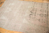 Distressed Oushak runner showcasing geometric plant motifs in muted silver and pale rose.