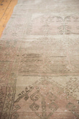 Distressed texture of the Oushak runner, showing pale dusty rose and silver geometric motifs.