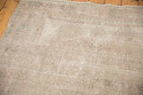 Faintly patterned Oushak rug pile with even wear, beige, pale rose, oxidized silver.